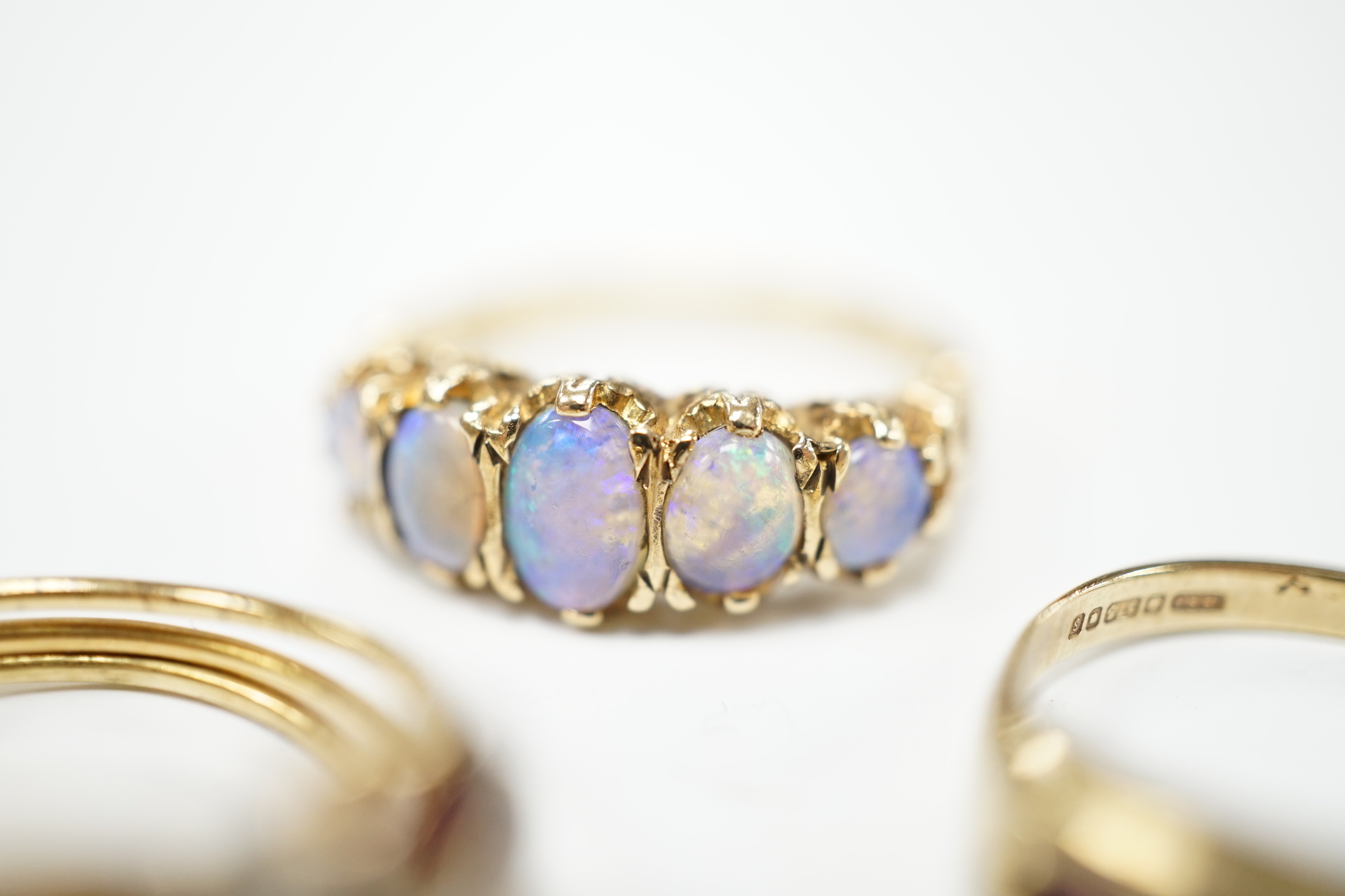 Two recent 9ct gold and gem set rings, including graduated five stone opal half hoop ring, together with a continental and gem set triple shank ring, gross weight 10.5 gram.